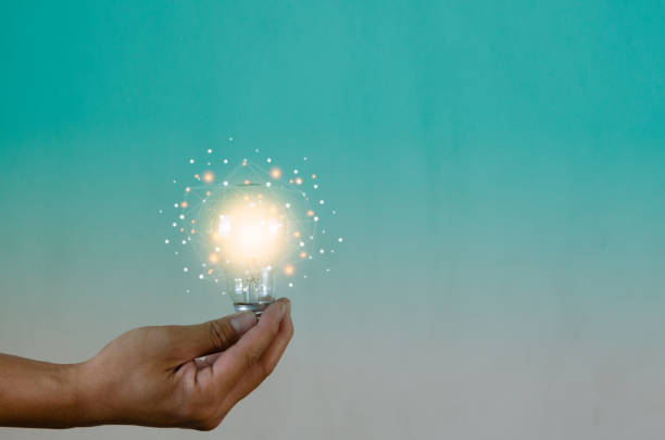 istock Man holding light bulbs ideas innovation technology and creative business concept. 1418075715