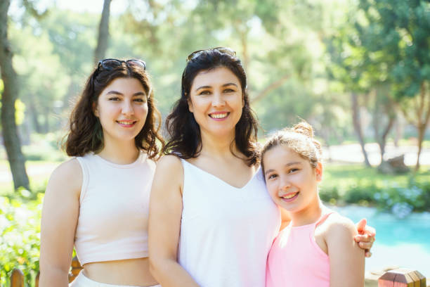 istock Mother with her lovely daughters posing outdoors 1418076918