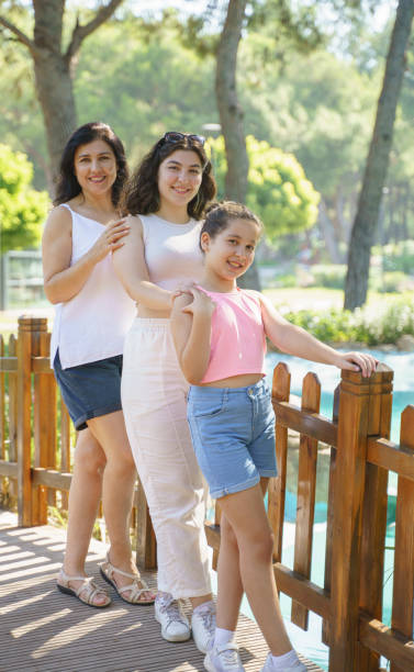 istock Mother with her lovely daughters posing outdoors 1418076967