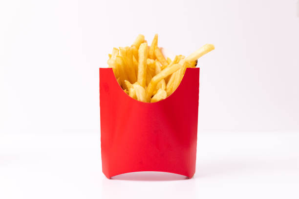French Fries In Package Golden french fries inside of a red container fried potato stock pictures, royalty-free photos & images
