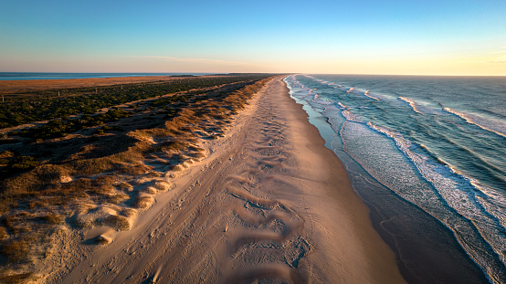 Aerial view of coastline and sand dunes of Ocracoke Island at sunrise, North Carolina, USA.