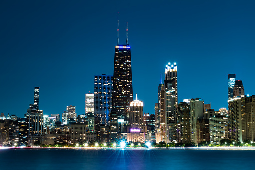 Chicago skyline reflects on Lake Michigan at night