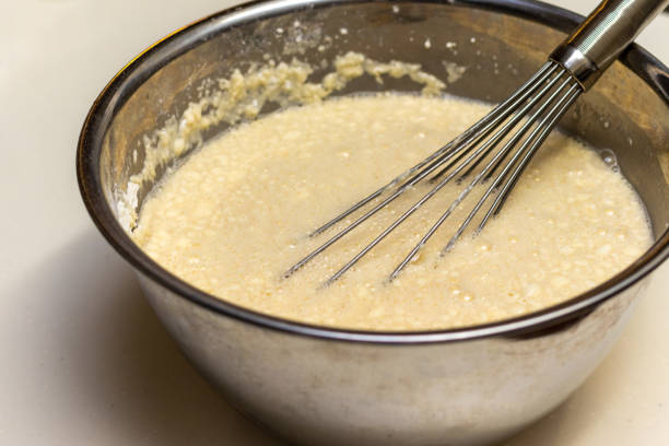 Batter and a whisk in a metal bowl