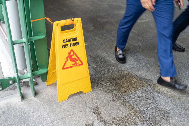 istock Yellow Caution slippery wet floor sign on the wet ground 1418092999