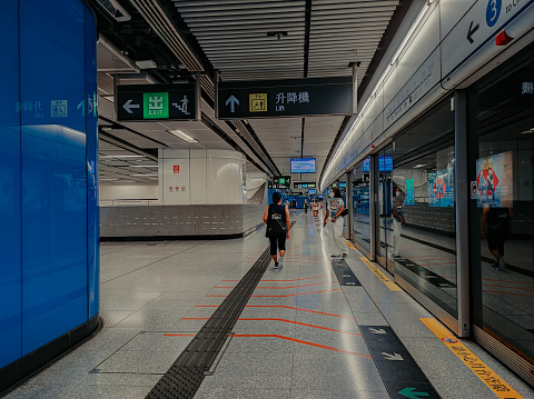 Hong Kong, August 2022 : Not many people inside the Hong Kong subway or MTR station. Still in the time of the Covid-19 pandemic.