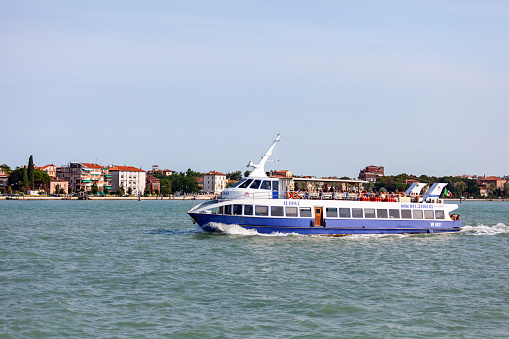 Venice, Italy - July 23, 2012: Passenger tour ferry boat in Venice carrying tourists to the port.