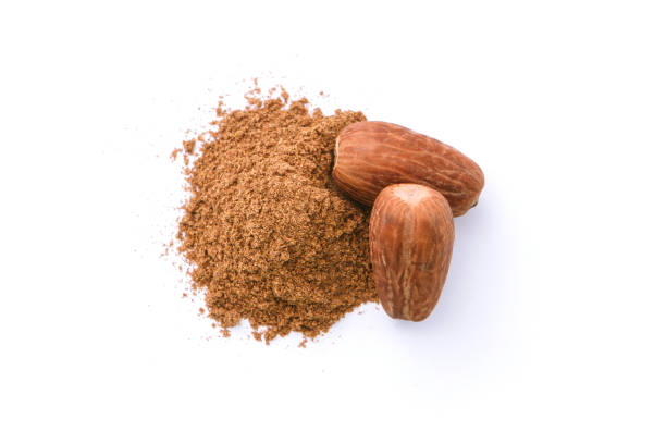 istock Dry nutmeg with powder isolated on white background. 1418102647