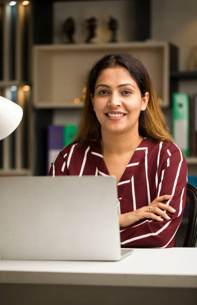 istock Happy woman using laptop at home 1418103432