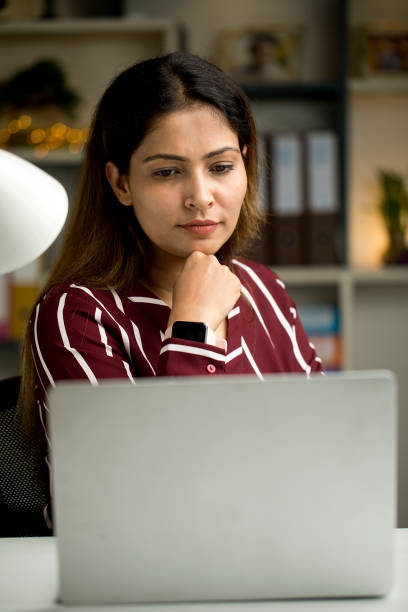 istock Thoughtful businesswoman using laptop at home 1418103500