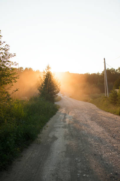 istock Evening road with the setting sun at sunset 1418104629