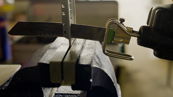 CU, Japanese man is cutting electrical materials with a tool.