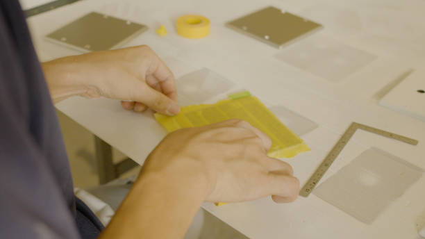 istock The man puts masking tape on. 1418105040