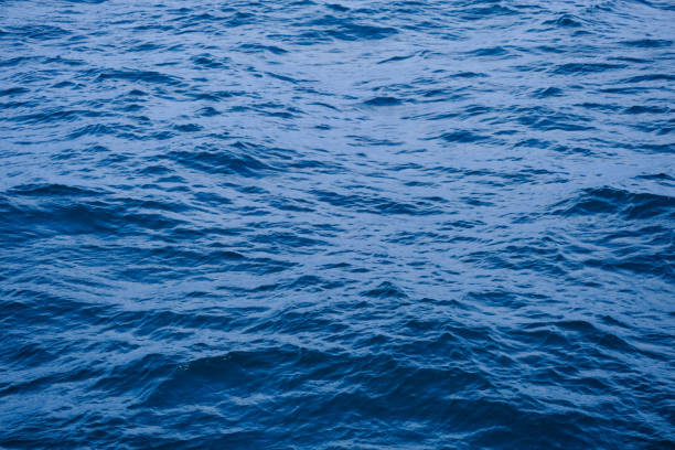 istock Background image of sea waves with sunlight reflected on the water surface. blue sea background in tropical sea 1418105092