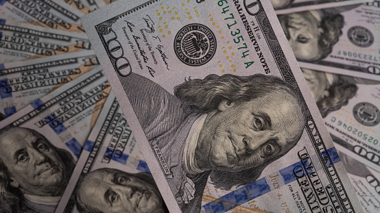 Bills in denominations of 100 American with a portrait of Benjamin Franklin Dollars