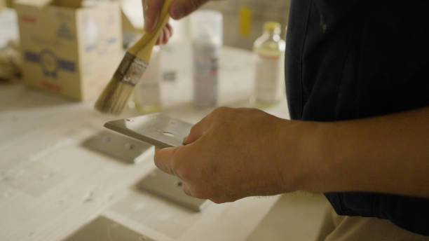 istock The men carefully paint electrical materials. 1418109430