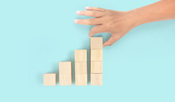 istock Business connecting piece of multi wood chart blocks steps in hand 1418110009