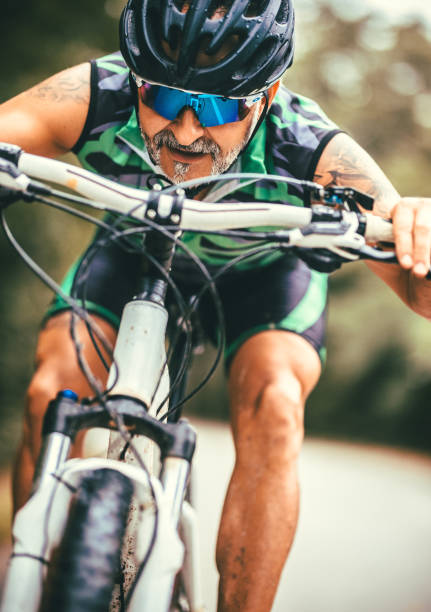 istock male mountain biker riding in a forest 1418110444