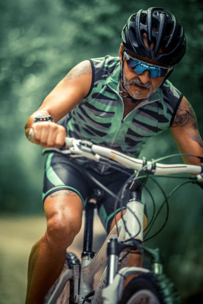 istock male mountain biker riding in a forest 1418110461
