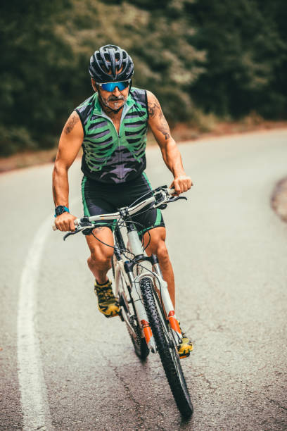 istock male mountain biker riding in a forest 1418110526