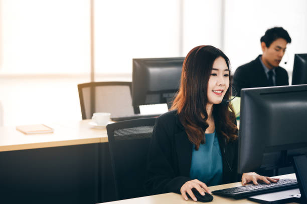 istock Young business staff asian woman working with headphone and computer for support. 1418112803