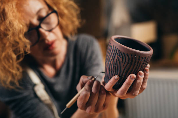 istock woman sculptor working in her atelier 1418112863