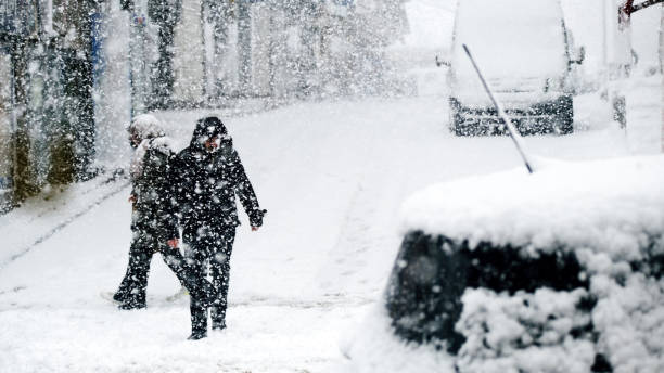 woman is unrecognizable in heavy snowfall. - people cold frozen unrecognizable person imagens e fotografias de stock