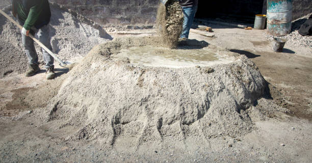 istock Worker prepare concrete with shovel at construction site. 1418114911