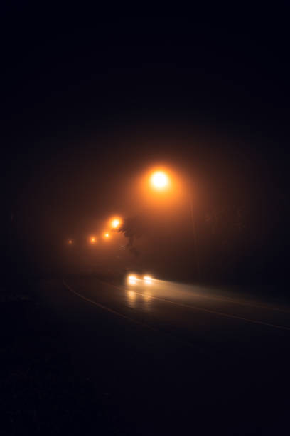 istock fog at night road and orange trees 1418117056