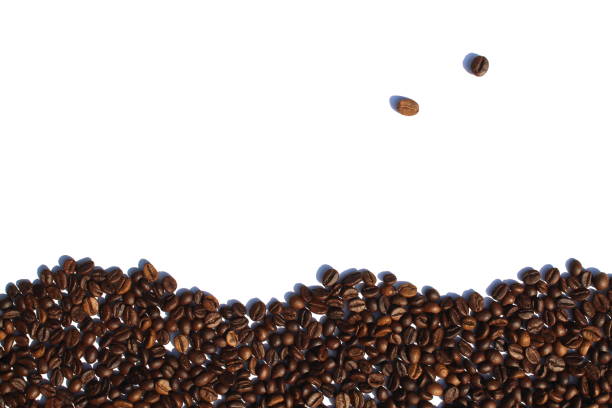 istock Coffee beans are scattered over a white isolated background. 1418117209