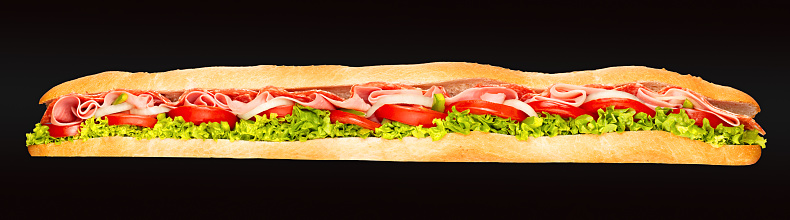 Ham and salami with vegetables Submarine sandwich in a wide panorama image in high resolution