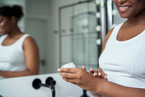 istock Young African-American  woman testing and applying face cream on hand 1418120550