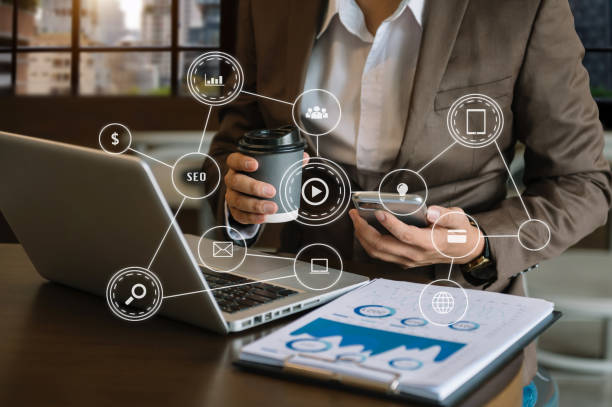 istock Businessman using mobile phone and laptop computer with business intelligence concept. with VR icon 1418125940