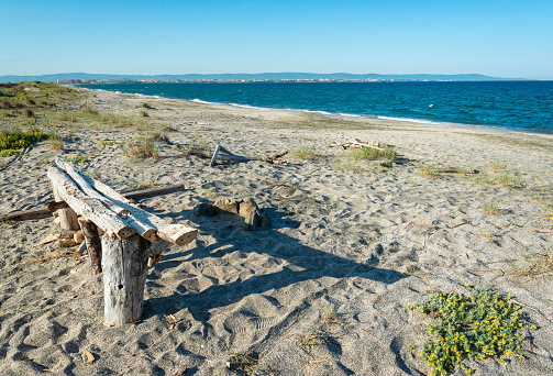 Homemade bench on the shore of the Black Sea on the sand spit between Pomorie and Aheloy towns. Bulgaria Europe.