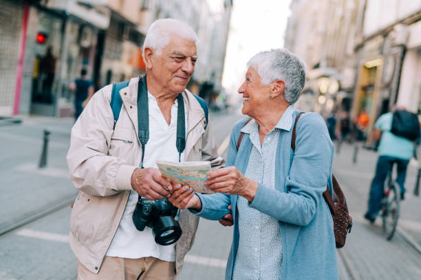 istock Cheerful senior tourists exploring foreign city using a map. 1418127981