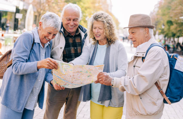 istock Cheerful senior tourists exploring foreign city using a map. 1418127992
