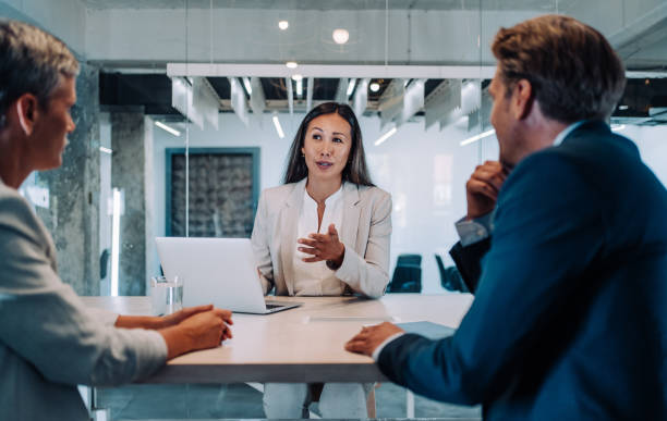 istock Group of business persons talking in the office. 1418128100