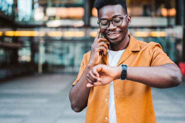 istock Cheerful young man talking on mobile phone in the city. 1418128136