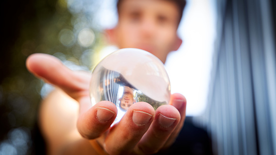 Girl in city holding crystal ball with beautiful bokeh