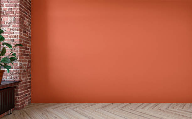 istock Empty unfurnished nostalgic retro living room with an orange colored plaster wall and partly ruined brick wall 1418131997