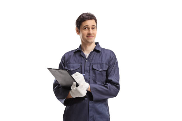 istock Young male worker in a uniform holding a clipboard 1418132171