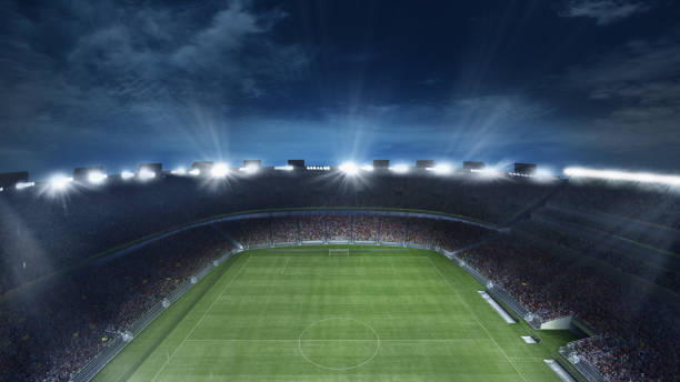 istock Empty football field with flashlights and dark night sky background. Stadium with filled stands with sports soccer fans. 1418132871