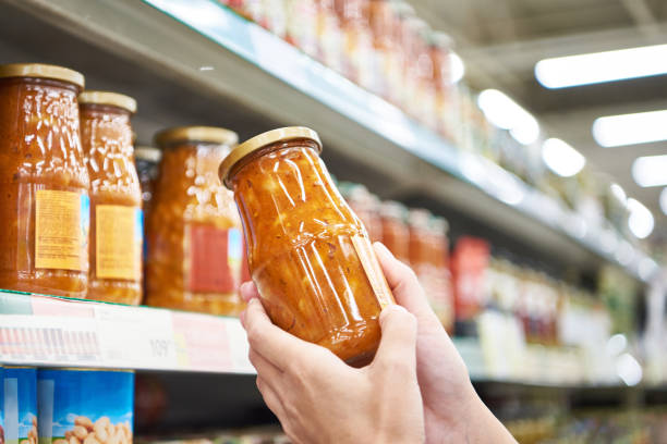 istock Jar of beans with vegetables in hands in store 1418133806