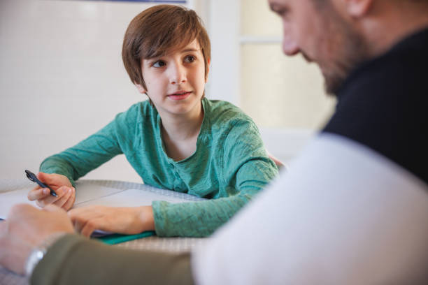 istock Home-schooled boy looking at his tutor with uncertain look on his face 1418133857