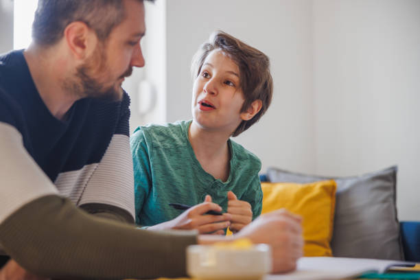 istock Home-schooled boy looking at his father with surprise 1418133964
