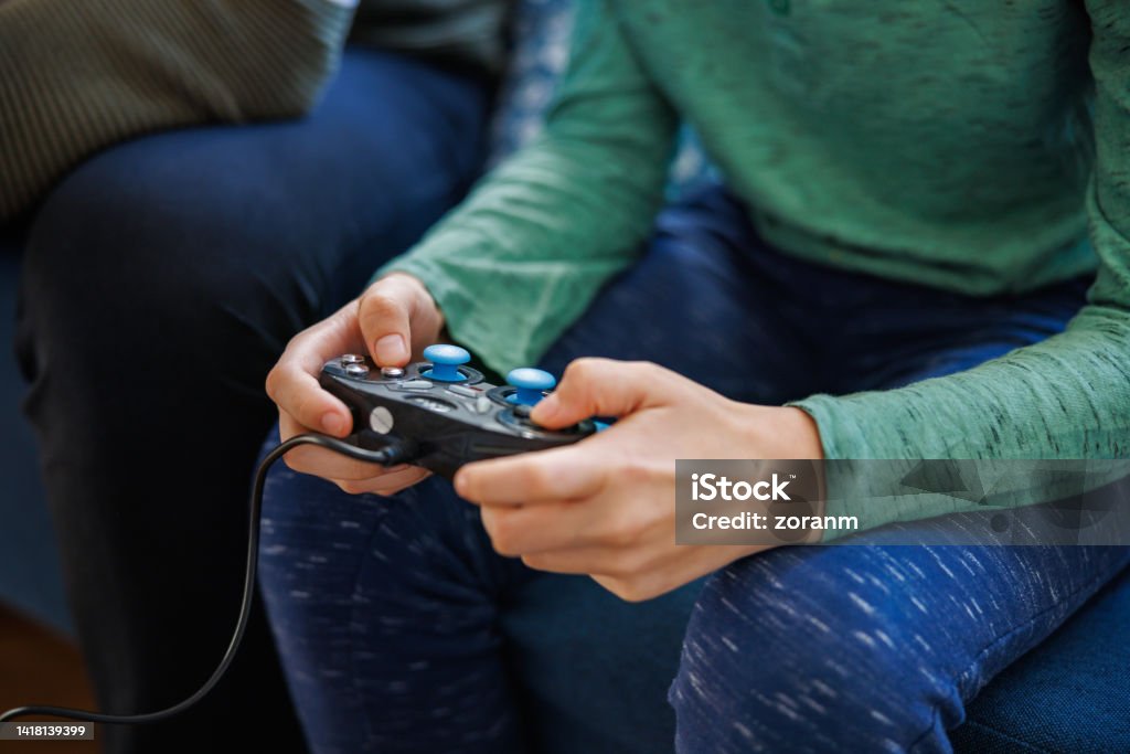Person Using Game Controller Using Game Controller And Playing Video Games At Home Stock Photo ...