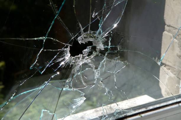 istock Window glass shattered by a shell fragment. 1418139787