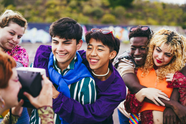 istock Young diverse people having fun with old vintage camera outdoor 1418144732