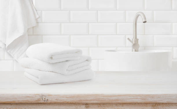 istock Stack of fresh towels on table in bathroom with space 1418146020
