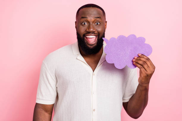 istock Photo of excited pretty guy dressed white shirt smiling holding talking cloud empty space isolated pink color background 1418146105
