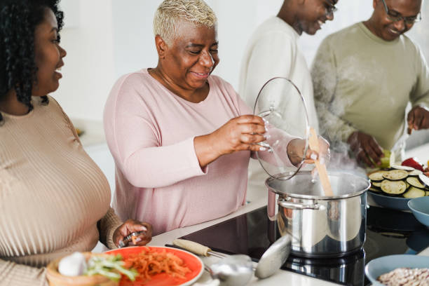 istock Happy black family cooking inside kitchen at home 1418146383